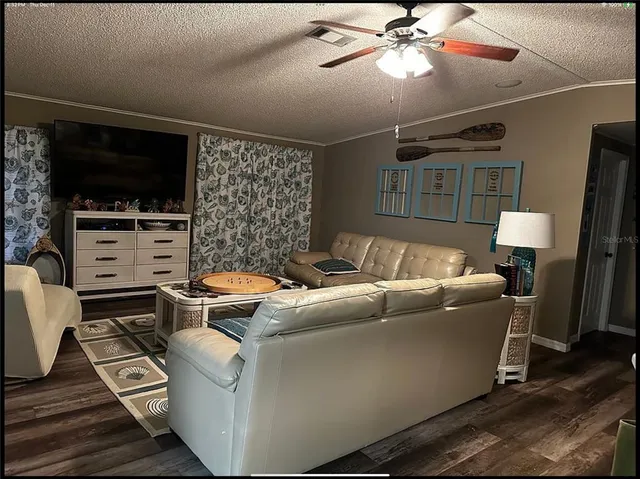 a large bed sitting in a bedroom next to a bathroom sink with wooden floor