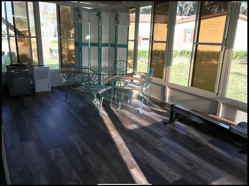 90 Whipporwill Court Ellenton, FL 34222 - Photo 24 of 34 a view of a large room with wooden floor and a chair