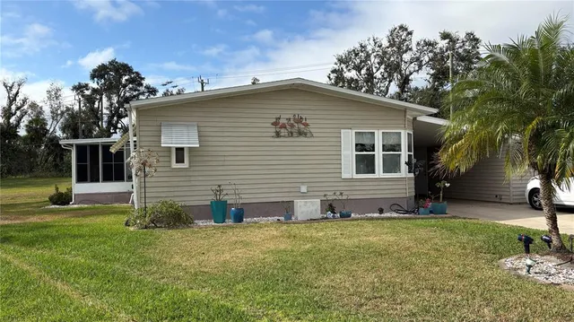 a view of a house with a yard and sitting area