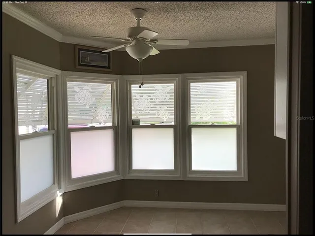 a living room with furniture a flat screen tv and a lamp