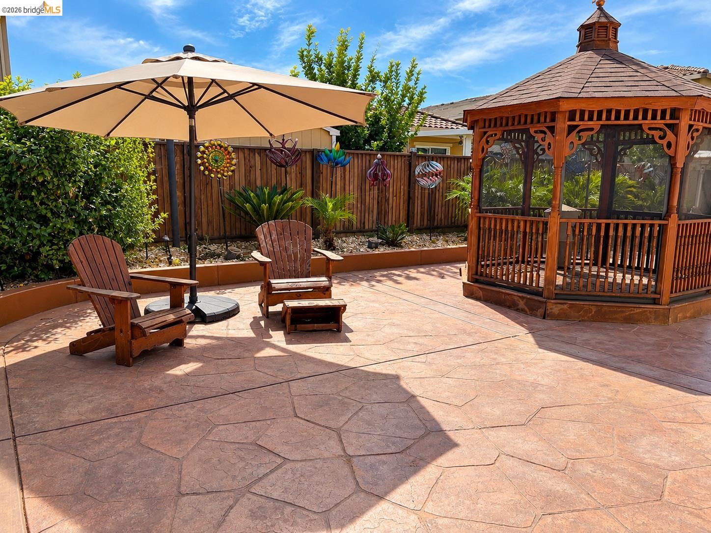809 Ibis Road Oakley, CA 94561 - Photo 17 of 32 Stamped concrete patio featuring a wood gazebo with screening and a wooden privacy fence