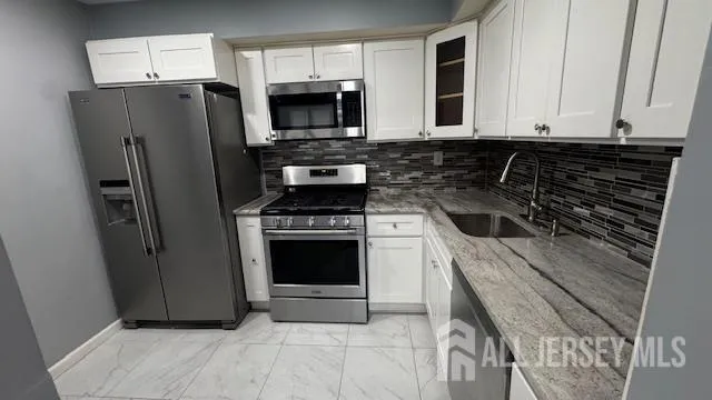 a kitchen with a refrigerator stove and microwave