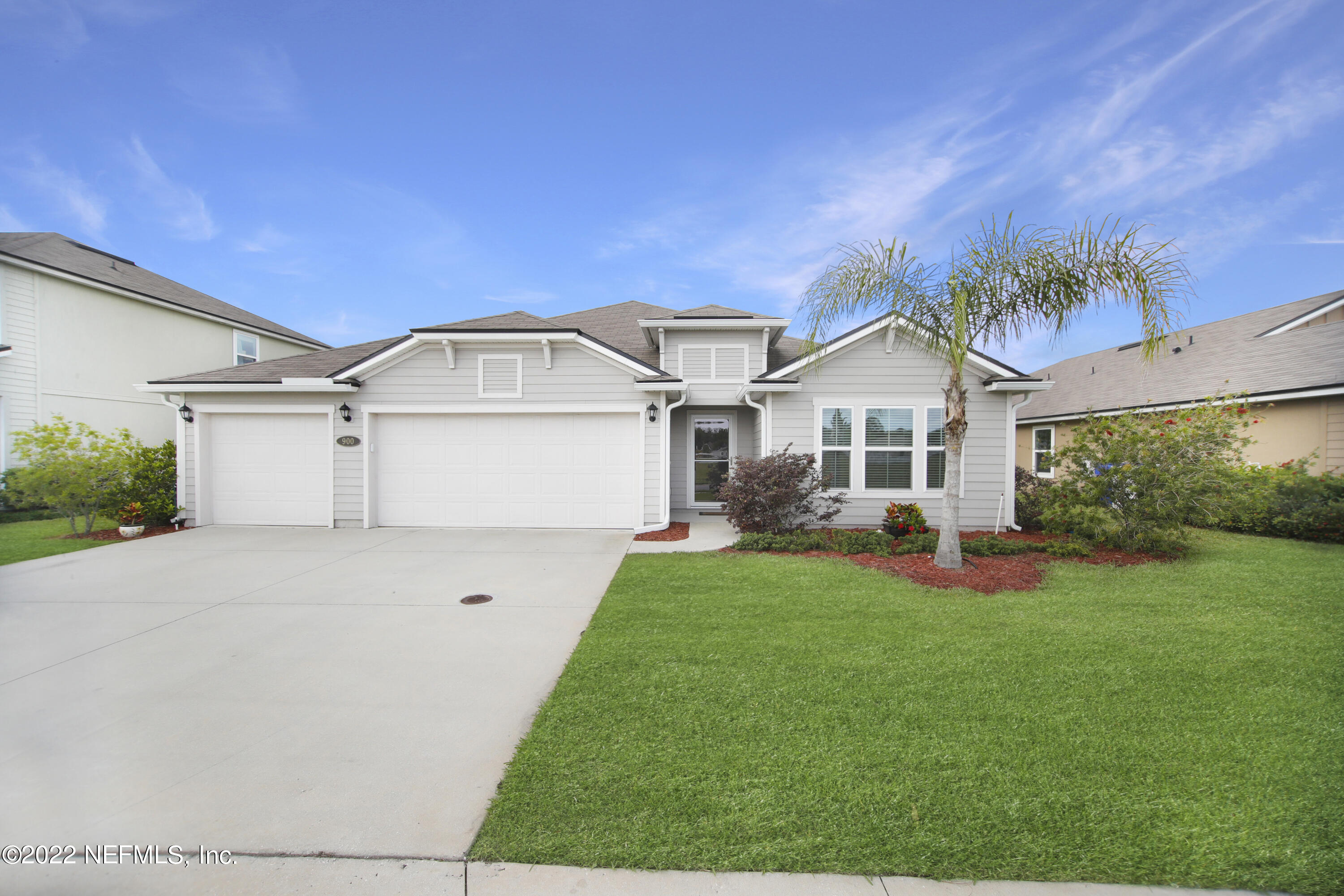 900 Deer Crossing Road St. Augustine, FL 32086 - Photo 1 of 29 a front view of a house with a yard and garage