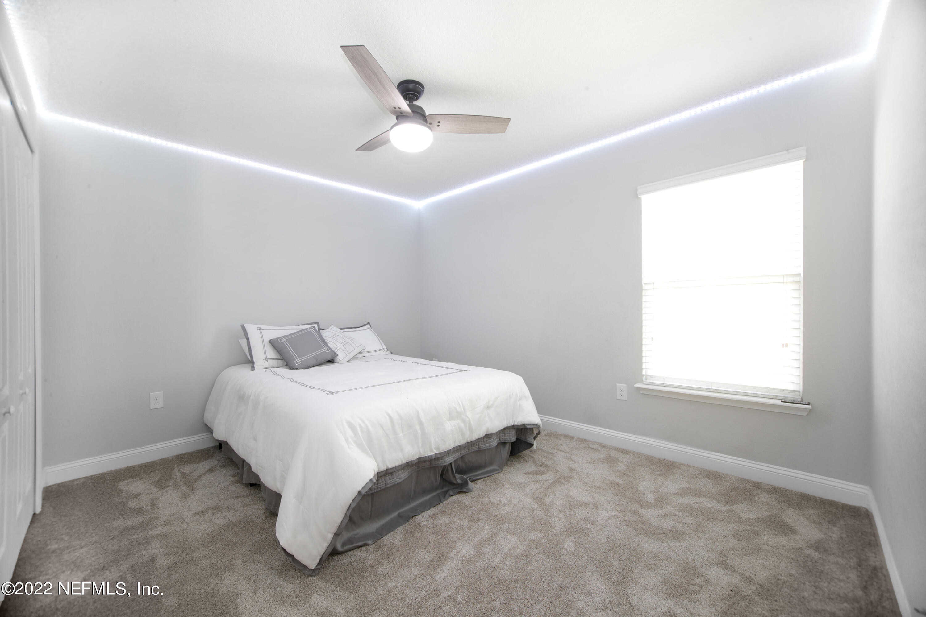 900 Deer Crossing Road St. Augustine, FL 32086 - Photo 14 of 29 a large bed sitting in a bedroom next to a window