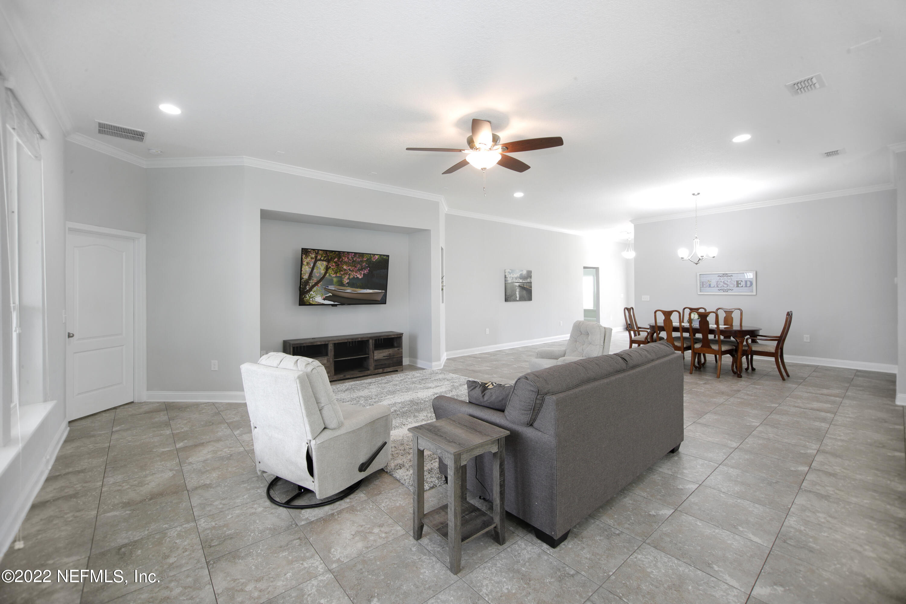 900 Deer Crossing Road St. Augustine, FL 32086 - Photo 2 of 29 a living room with furniture a ceiling fan and a window