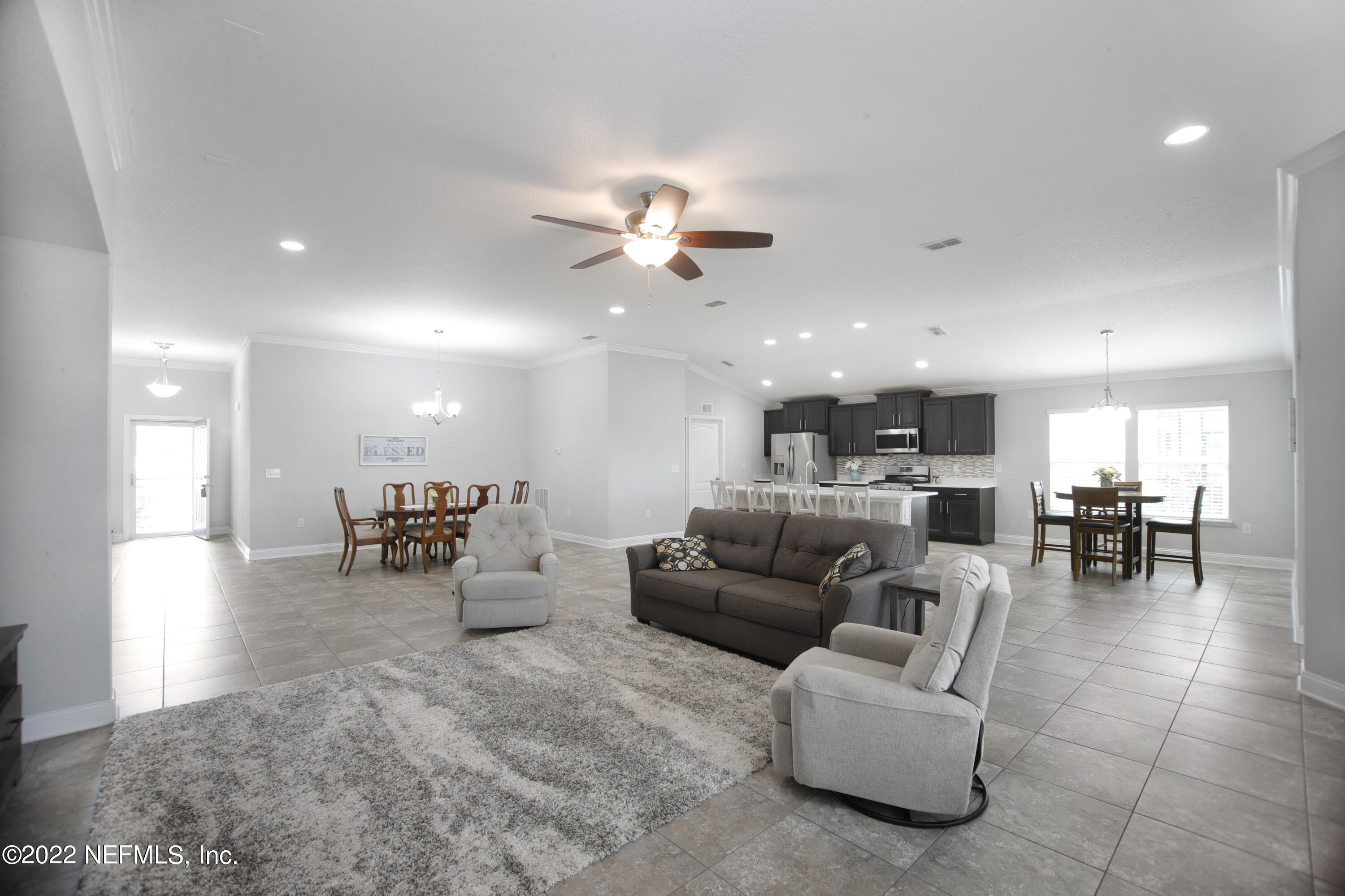 900 Deer Crossing Road St. Augustine, FL 32086 - Photo 3 of 29 a living room with furniture and kitchen view