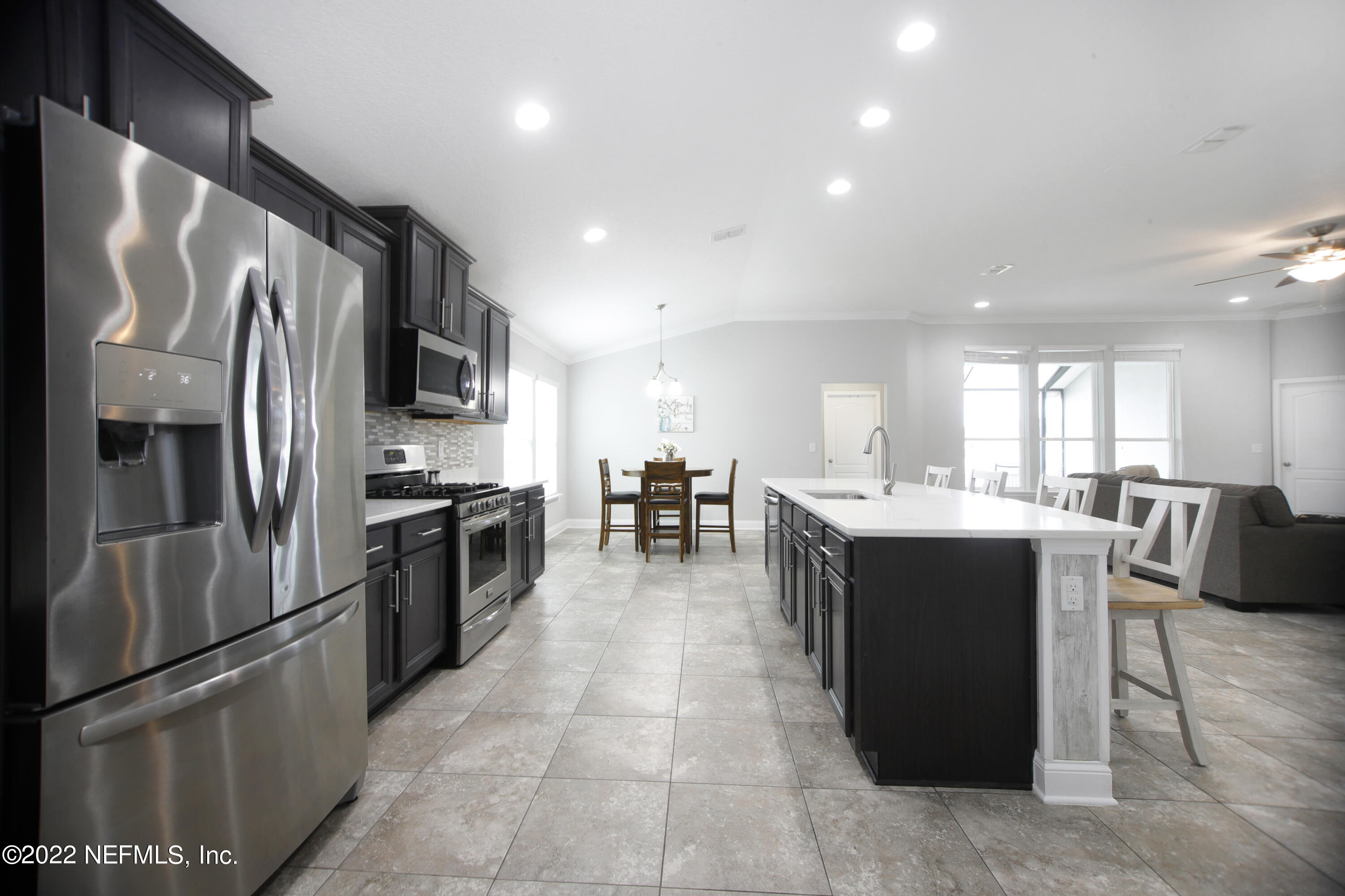 900 Deer Crossing Road St. Augustine, FL 32086 - Photo 6 of 29 a kitchen with stainless steel appliances granite countertop a refrigerator a sink dishwasher a stove and a refrigerator