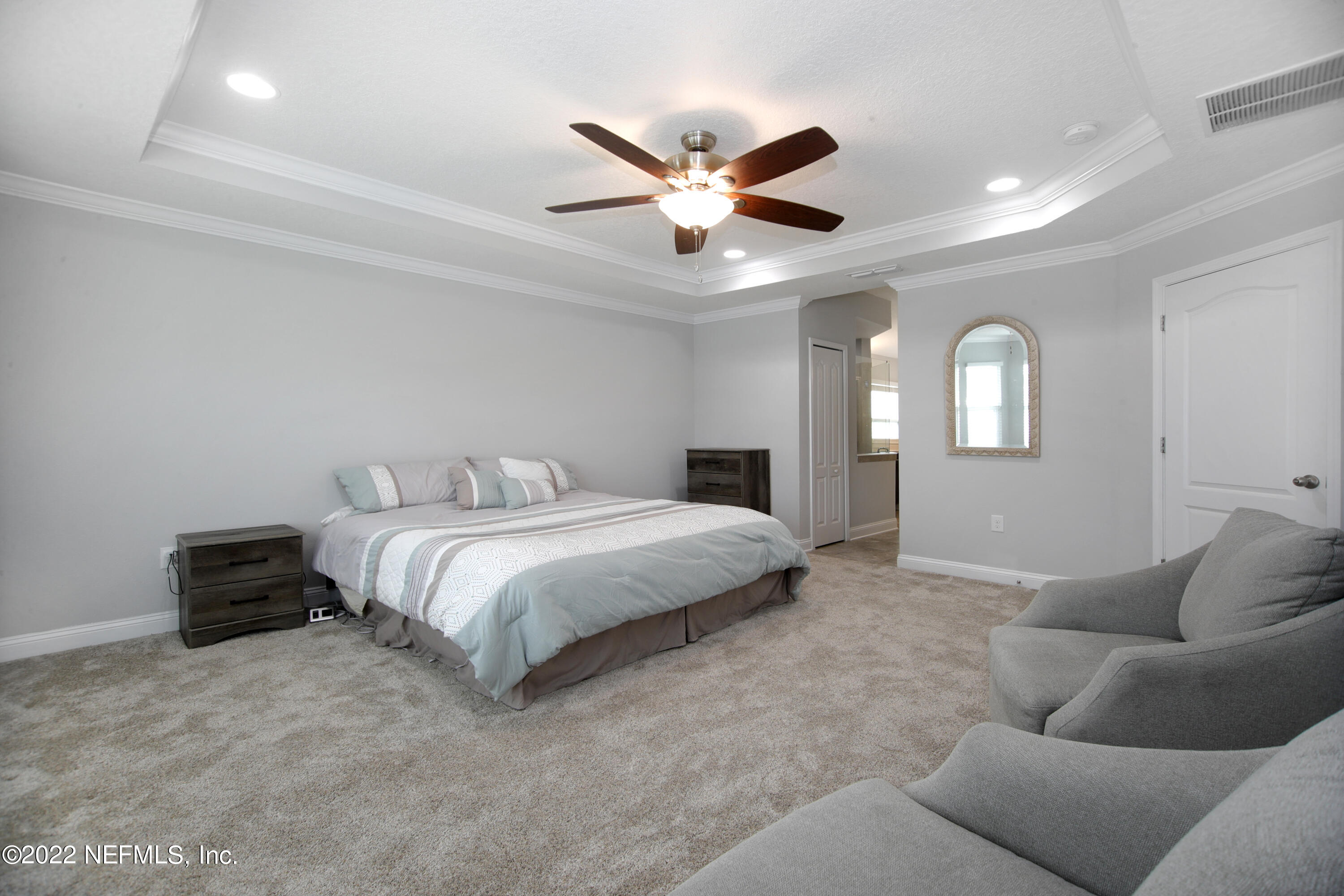 900 Deer Crossing Road St. Augustine, FL 32086 - Photo 9 of 29 a spacious bedroom with a bed and ceiling fan