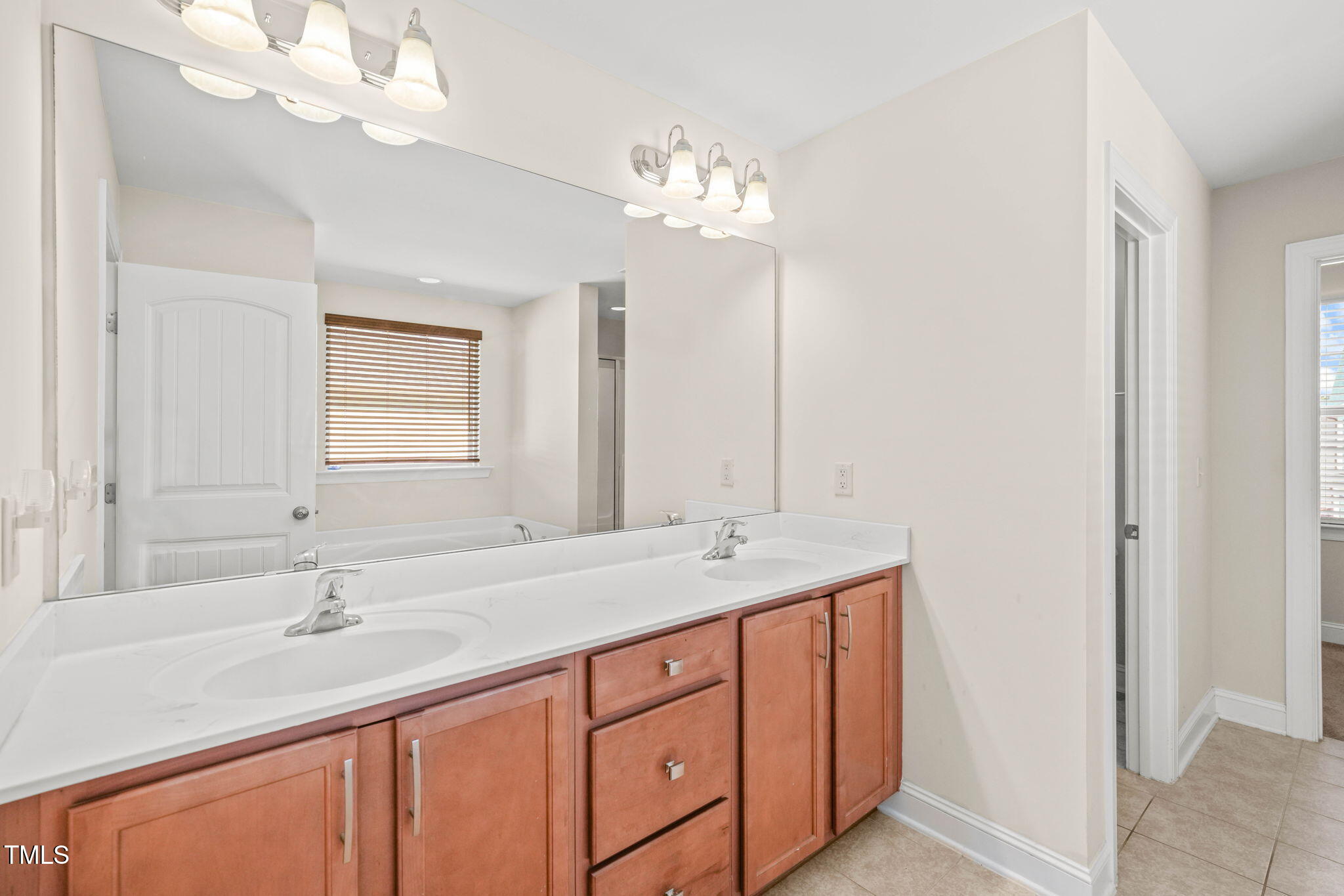 4508 Brintons Cottage Street Raleigh, NC 27616 - Photo 24 of 46 a bathroom with a double vanity sink and a mirror