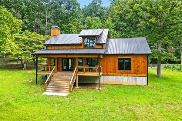 a front view of house with a yard and trees