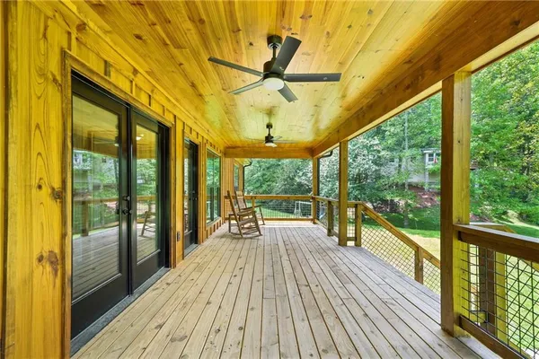 a view of a patio with a table chairs and wooden floor