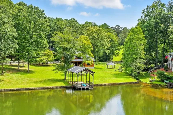 a view of a lake with houses in the background