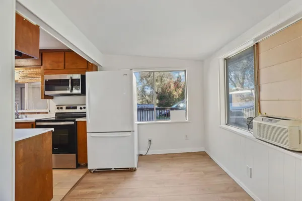 a kitchen with stainless steel appliances a refrigerator and a stove