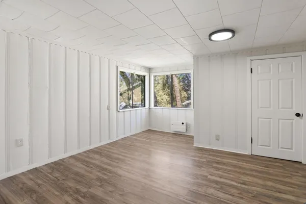 a view of an empty room with wooden floor