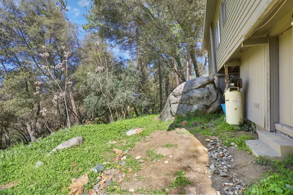 a view of a small house with a yard