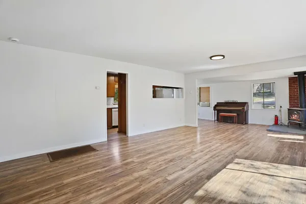 a big room with wooden floor and windows