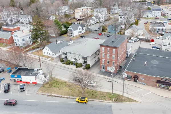 an aerial view of multiple houses with yard