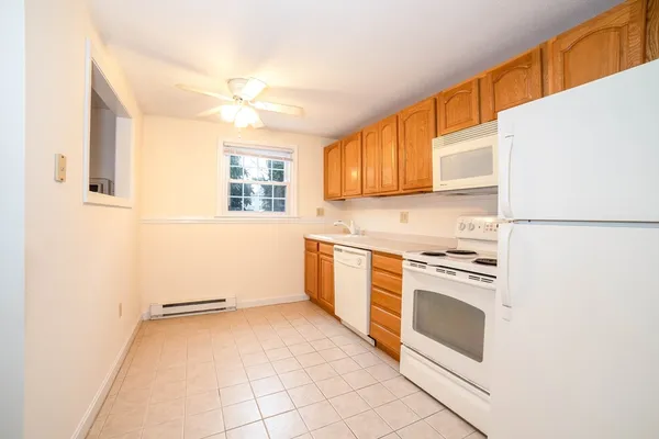 a kitchen with a stove a sink and a refrigerator
