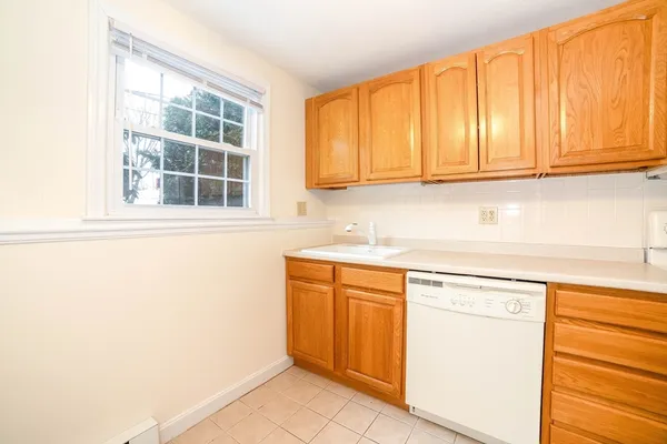 a kitchen with granite countertop cabinets stainless steel appliances and a sink