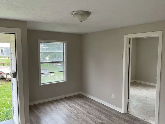 an empty room with windows and closet