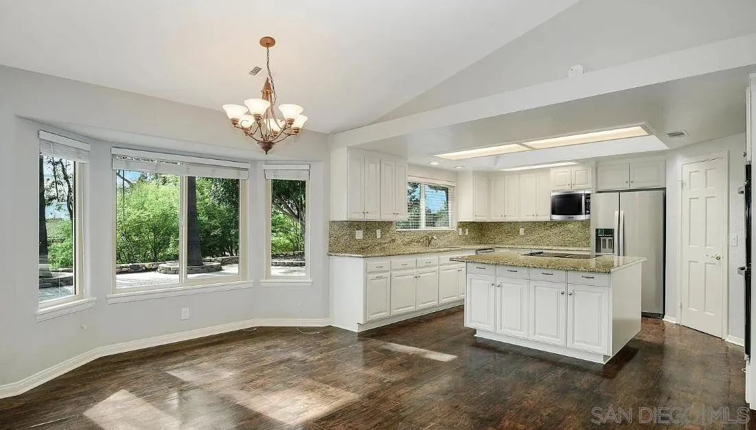 14525 Millards Ranch Lane Poway, CA 92064 - Photo 9 of 29 a kitchen with stainless steel appliances granite countertop a stove and a white cabinets