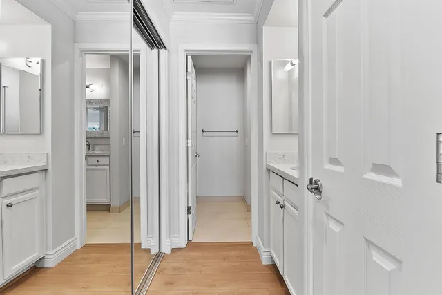 a view of a hallway with a wooden door