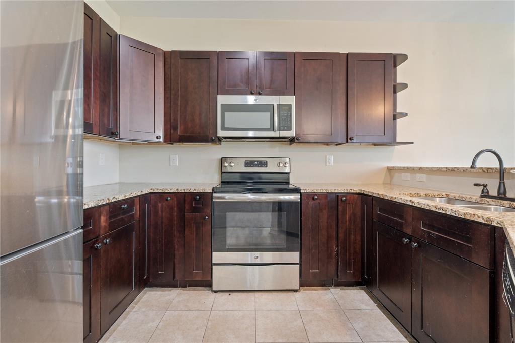 104 Eagle Meadow Drive Weatherford, TX 76087 - Photo 12 of 40 a kitchen with a sink and a stove top oven