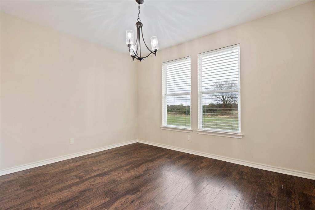 104 Eagle Meadow Drive Weatherford, TX 76087 - Photo 16 of 40 a view of an empty room with wooden floor and a window