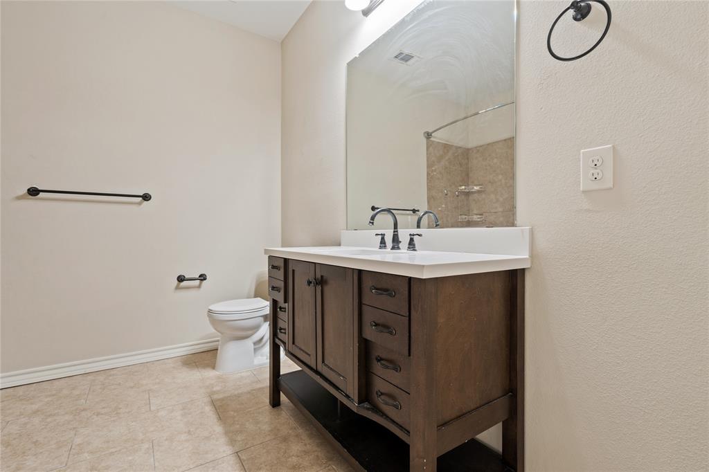 104 Eagle Meadow Drive Weatherford, TX 76087 - Photo 26 of 40 a bathroom with a sink vanity and toilet