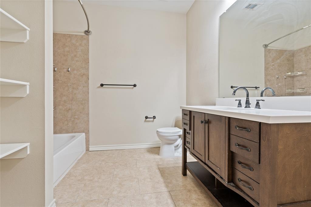 104 Eagle Meadow Drive Weatherford, TX 76087 - Photo 27 of 40 a bathroom with a sink a toilet and shower