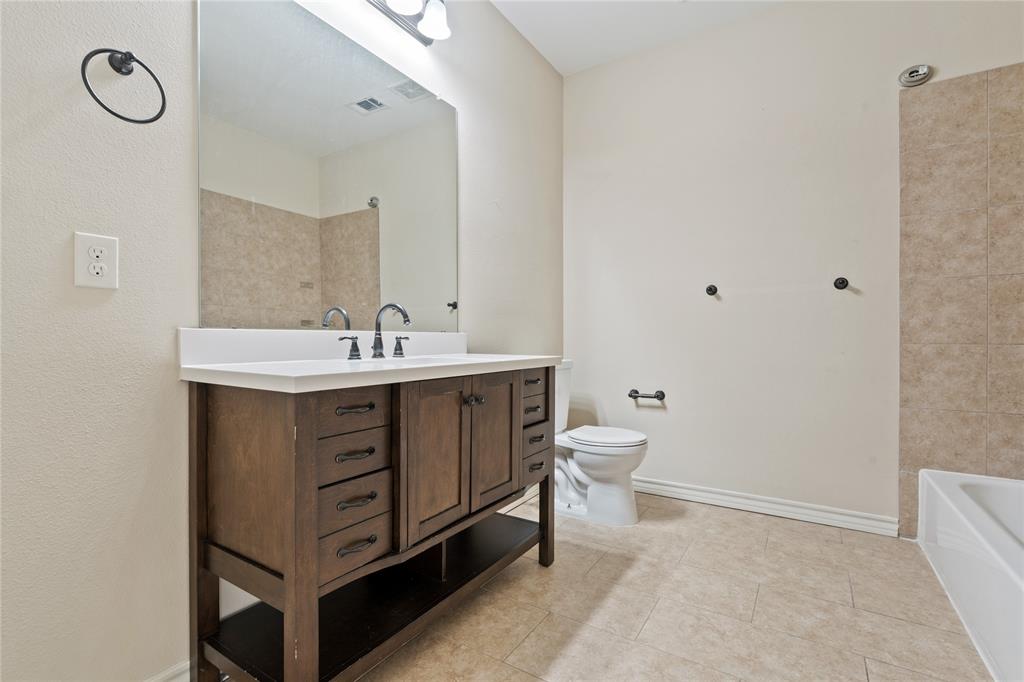 104 Eagle Meadow Drive Weatherford, TX 76087 - Photo 29 of 40 a bathroom with a sink vanity and a toilet
