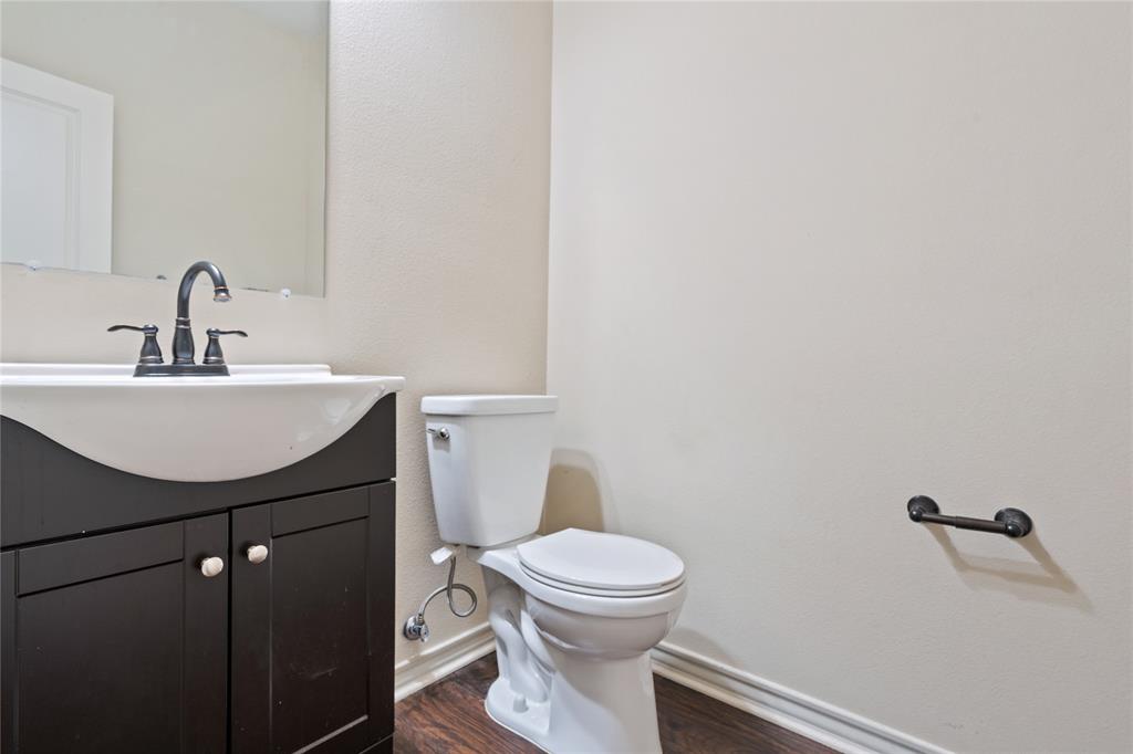 104 Eagle Meadow Drive Weatherford, TX 76087 - Photo 32 of 40 a bathroom with a sink a toilet and mirror