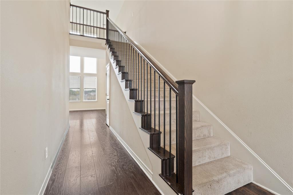 104 Eagle Meadow Drive Weatherford, TX 76087 - Photo 4 of 40 a view of staircase with wooden floor and white walls