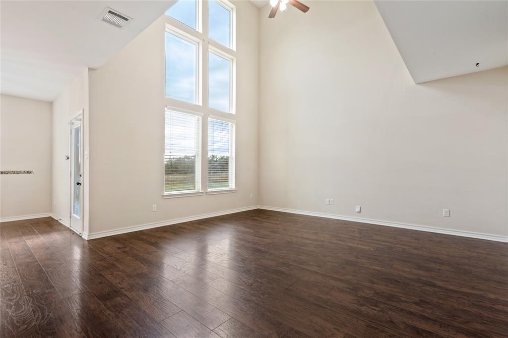 104 Eagle Meadow Drive Weatherford, TX 76087 - Photo 7 of 40 a view of an empty room with wooden floor and a window