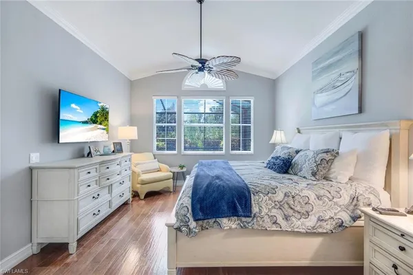 a bathroom with a granite countertop double vanity sink a mirror a bathtub and window