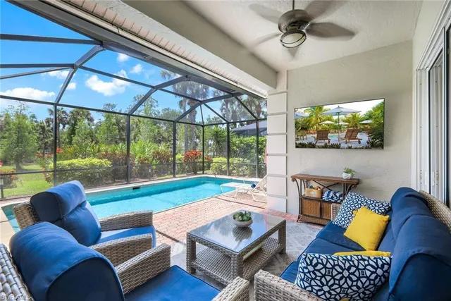 a view of a patio with a dining table and chairs under an umbrella