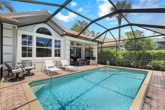 a view of a patio with a table chairs and a backyard