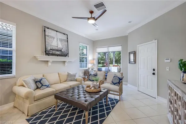 a living room with furniture and a view of kitchen