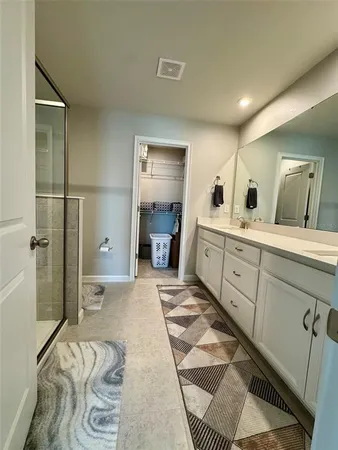 a spacious bathroom with a double vanity sink and a mirror