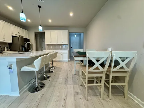 a view of a dining room with furniture and wooden floor
