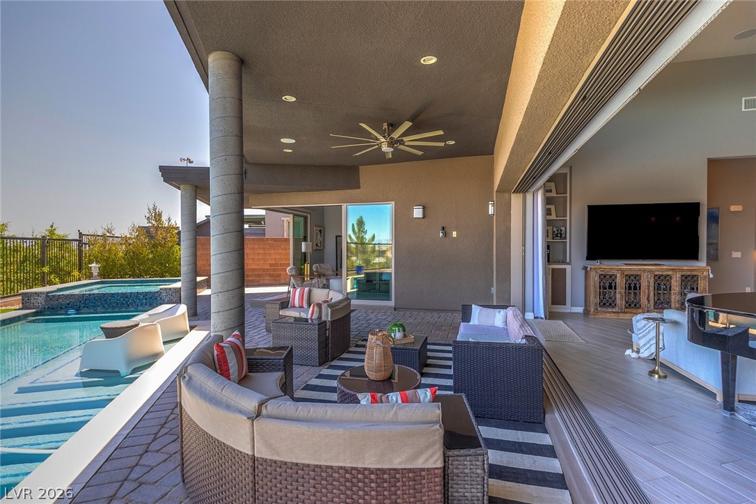 6014 Willow Ridge Court Las Vegas, NV 89135 - Photo 78 of 99 An inviting covered patio seamlessly blends outdoor relaxation with indoor comfort.