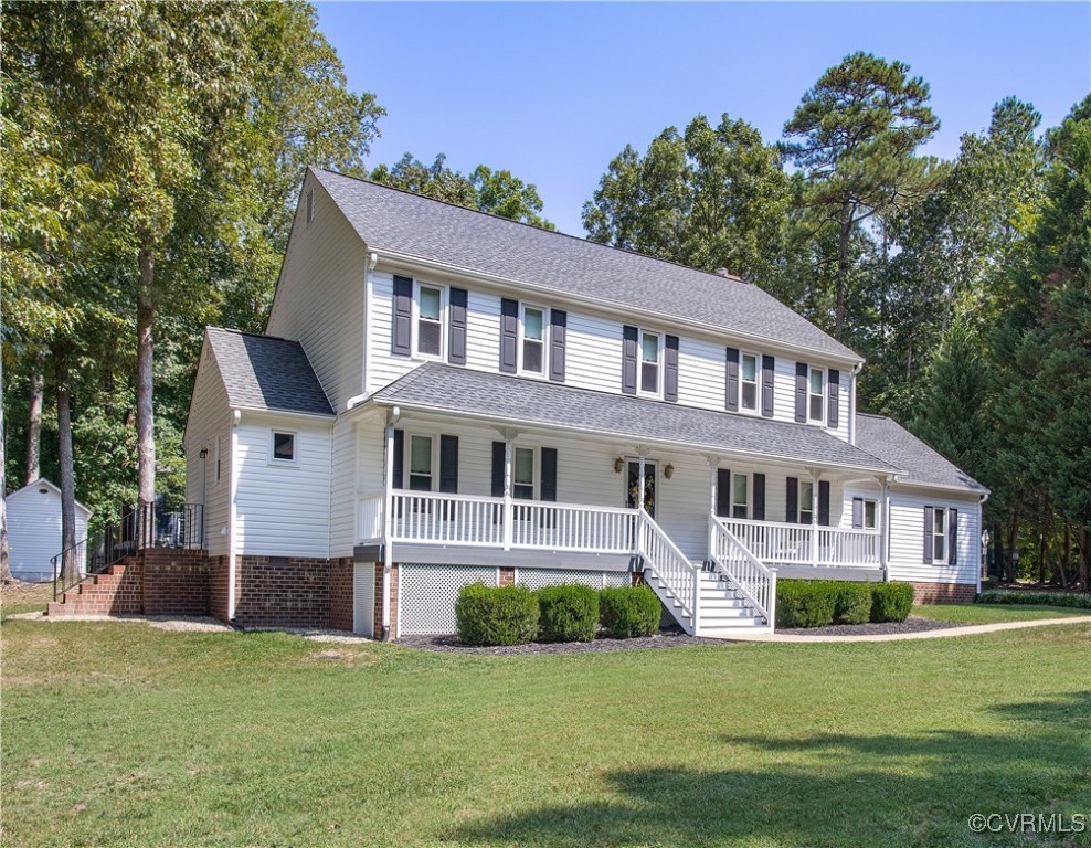 14200 Chimney House Road Midlothian, VA 23112 - Photo 3 of 44 a front view of a house with a garden and trees