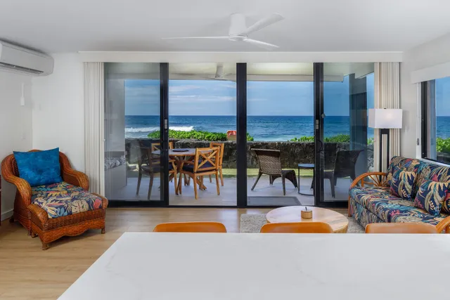 a living room with furniture and floor to ceiling window