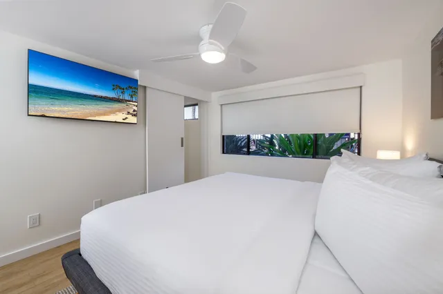 a large white bed in a white room