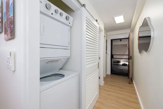 a view of a hallway with washer and dryer