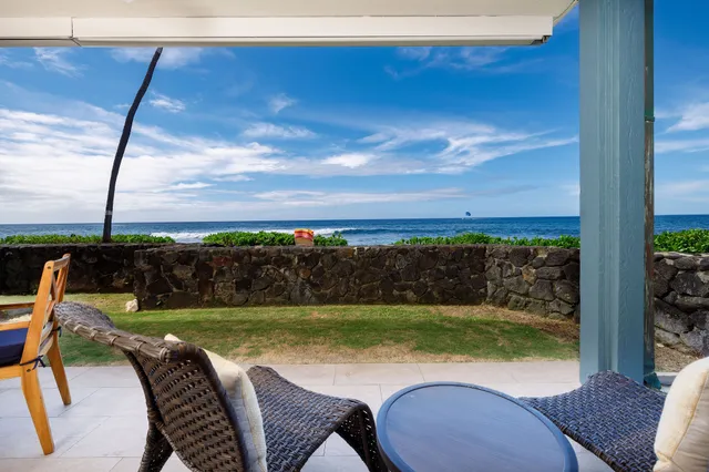 a view of a chairs and table in patio with a yard
