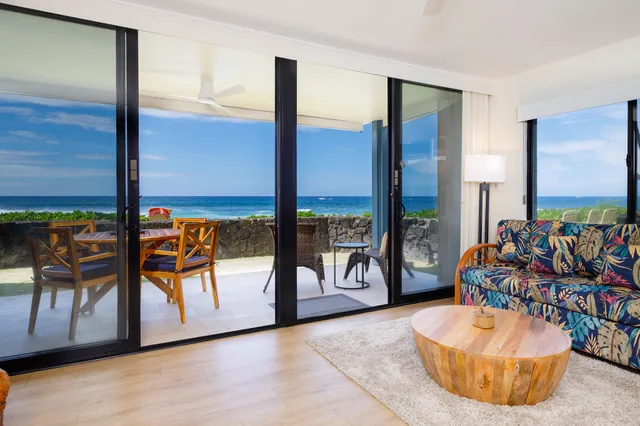 a living room filled with furniture and a floor to ceiling window
