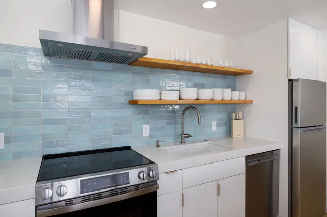 a kitchen with a sink cabinets and appliances