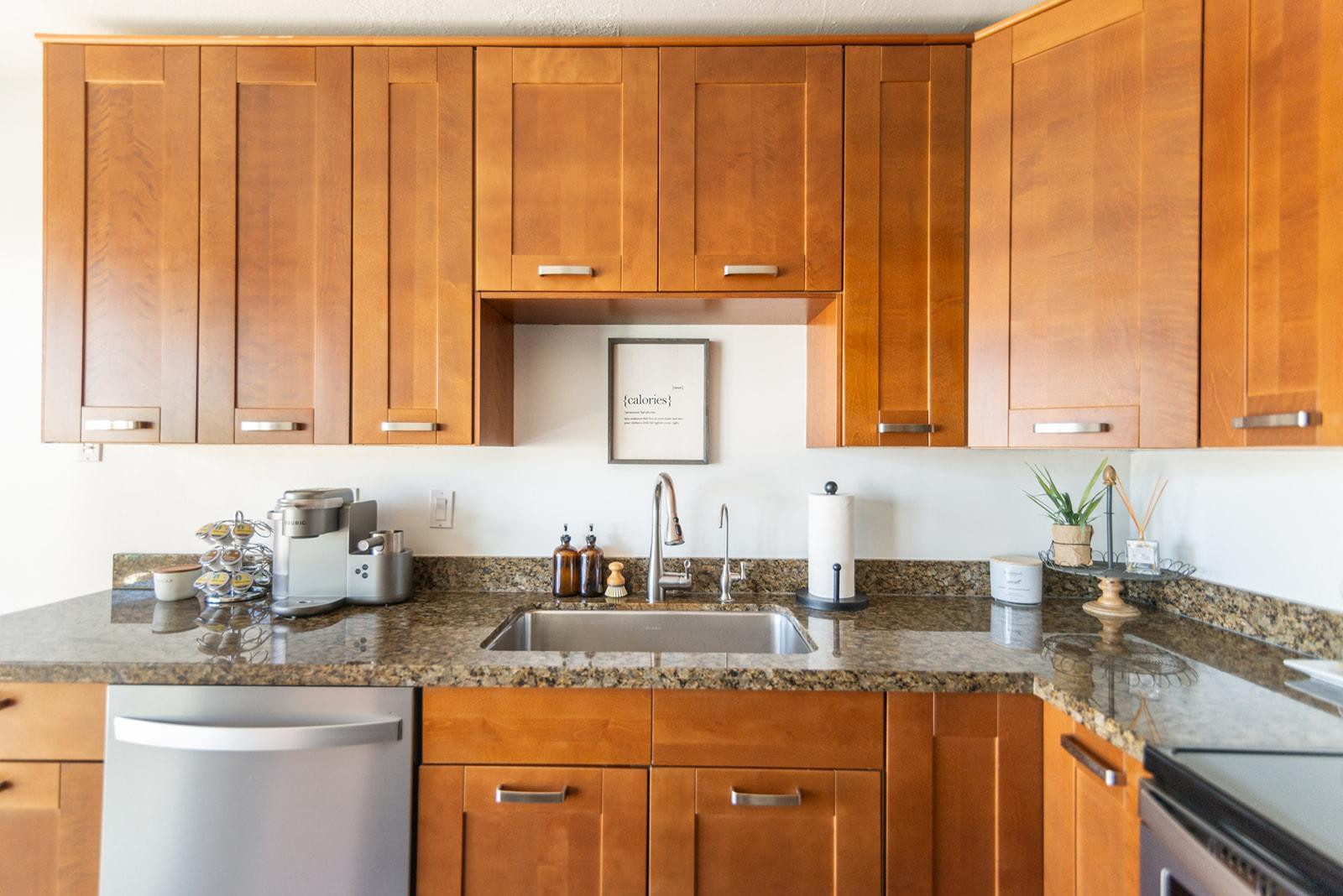 7435 East Granada Road Scottsdale, AZ 85257 - Photo 14 of 28 a kitchen with granite countertop a sink a stove and cabinets
