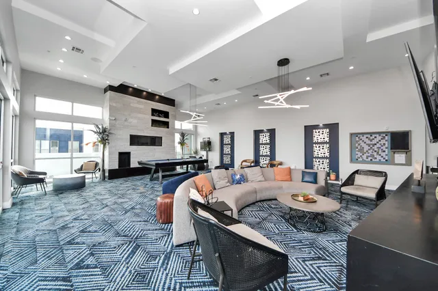 a kitchen with stainless steel appliances a refrigerator a sink a stove and white cabinets